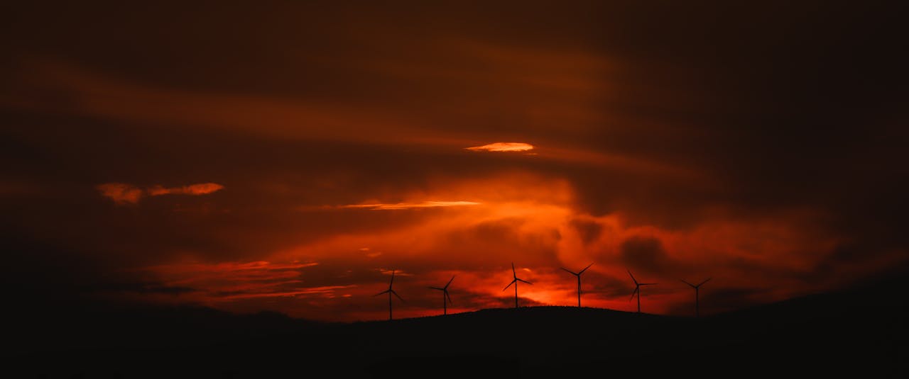 The Art of Drawing Readers In: Your attractive post title goes here Wind turbines silhouetted against a vibrant orange sunset sky, Şarköy, Türkiye.