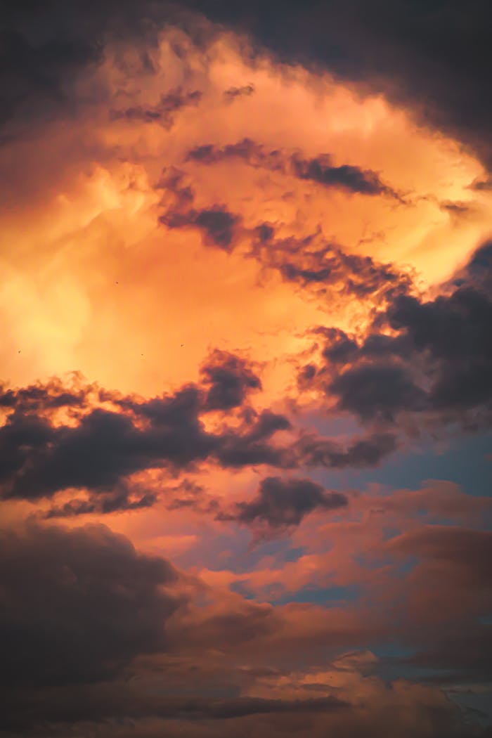 Vibrant sunset with dramatic orange and purple clouds, perfect for nature and sky-themed projects.